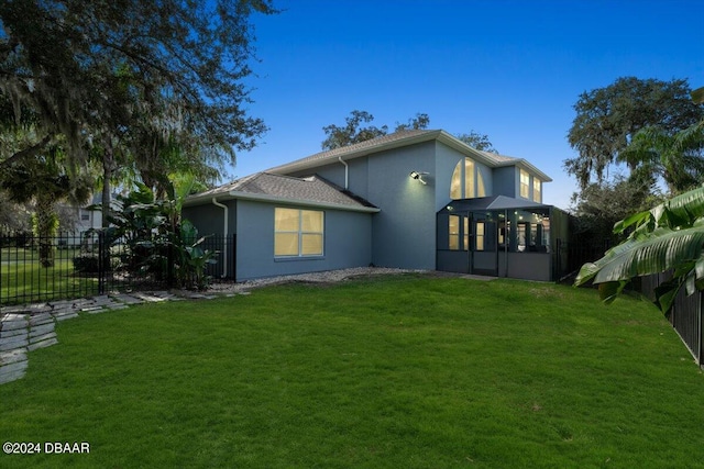 back of house featuring a yard