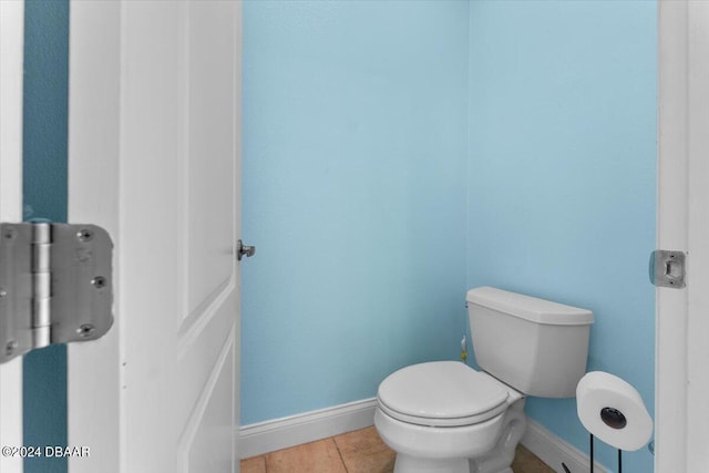 bathroom with toilet and tile patterned floors