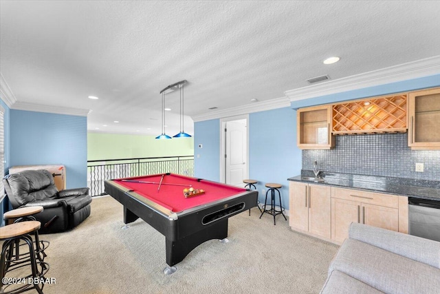 rec room with pool table, a textured ceiling, crown molding, light colored carpet, and indoor bar