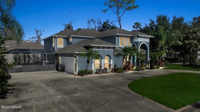 mediterranean / spanish-style house featuring a front yard and a garage