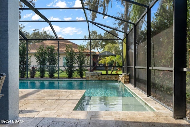 view of swimming pool with a lanai, pool water feature, and a patio area