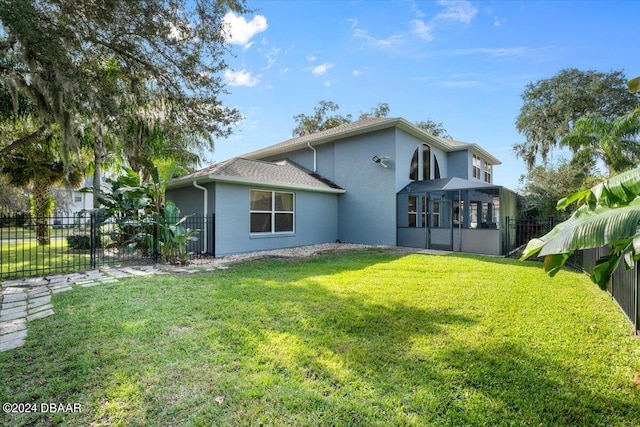 rear view of property with a lawn