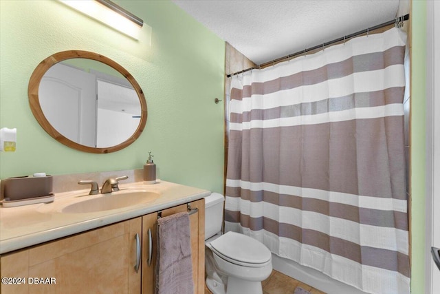 bathroom with vanity, curtained shower, a textured ceiling, and toilet