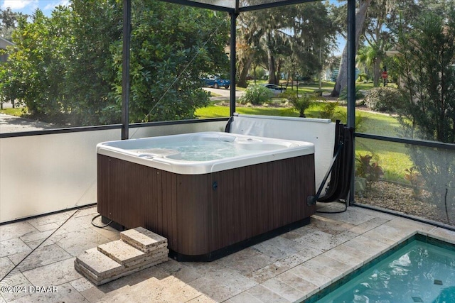 unfurnished sunroom featuring a hot tub