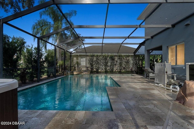 view of pool with a patio, central AC, and glass enclosure