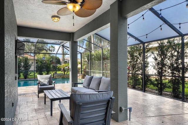 view of patio / terrace with ceiling fan, outdoor lounge area, and a lanai