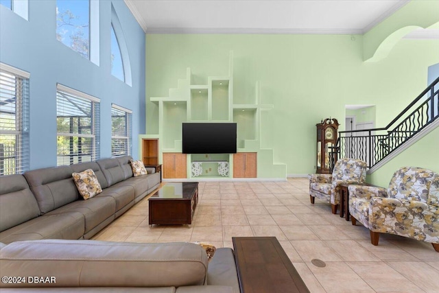 tiled living room with crown molding and a towering ceiling