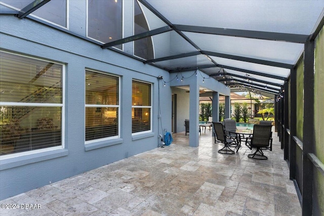 view of patio / terrace featuring glass enclosure