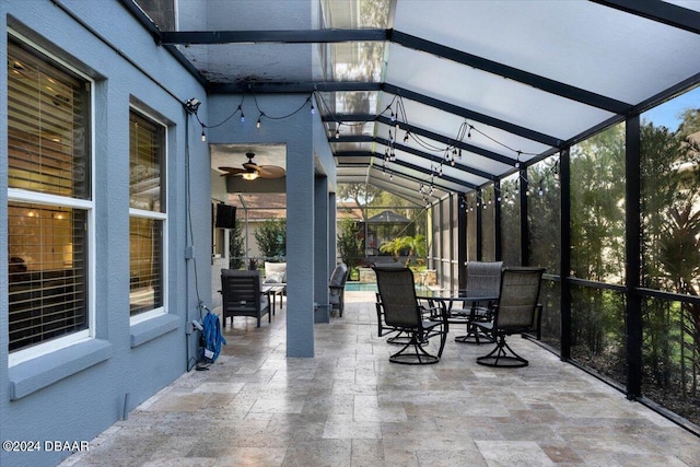 unfurnished sunroom featuring lofted ceiling with beams and ceiling fan