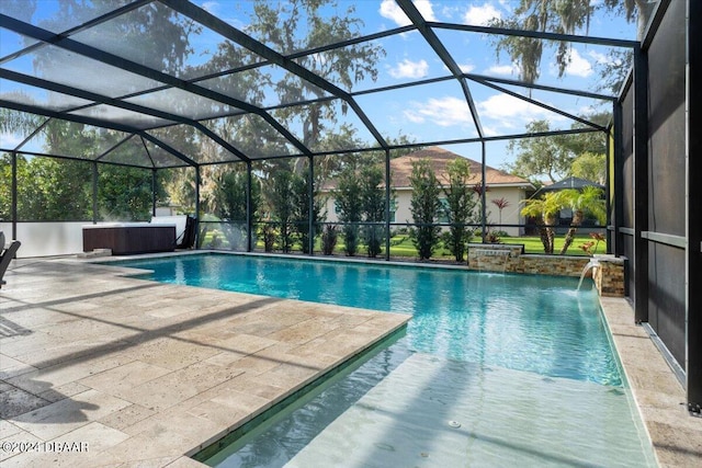 view of swimming pool featuring a hot tub, a patio area, a lanai, and pool water feature