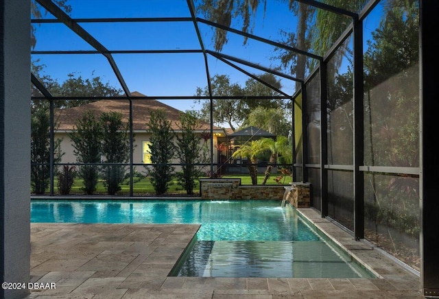 view of swimming pool featuring a lanai, a patio, and pool water feature