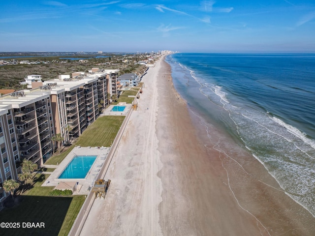 birds eye view of property with a view of the beach and a water view