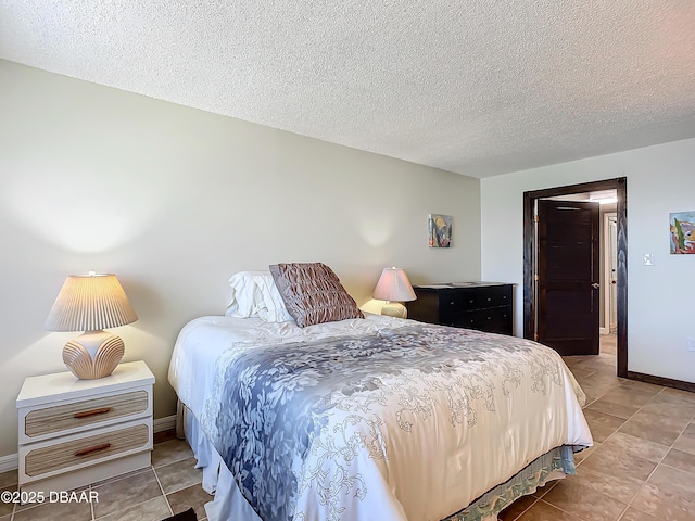 tiled bedroom featuring a textured ceiling