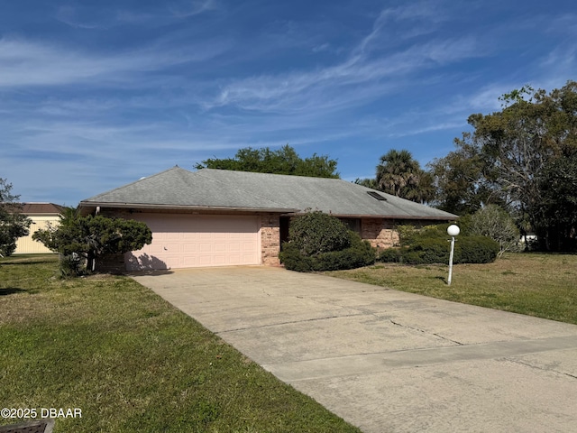 view of front of home featuring brick siding, an attached garage, concrete driveway, and a front yard