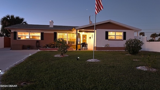 view of front of house with a front yard and fence