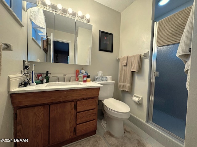 full bathroom with toilet, a shower stall, and vanity