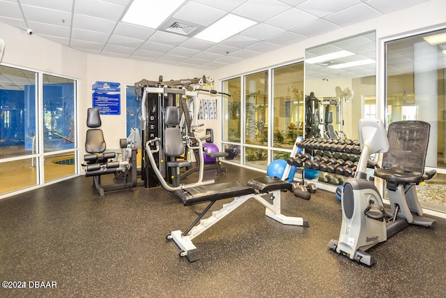 workout area featuring a drop ceiling