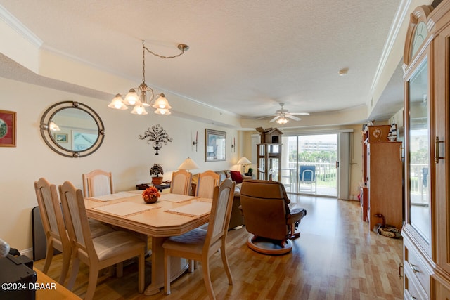 dining room featuring a textured ceiling, ceiling fan with notable chandelier, crown molding, and light hardwood / wood-style flooring