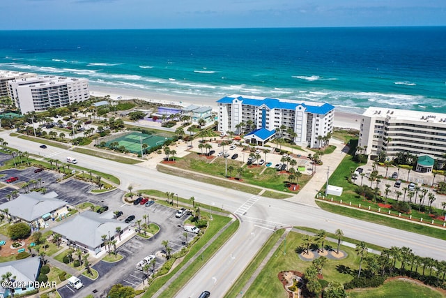 birds eye view of property with a beach view and a water view