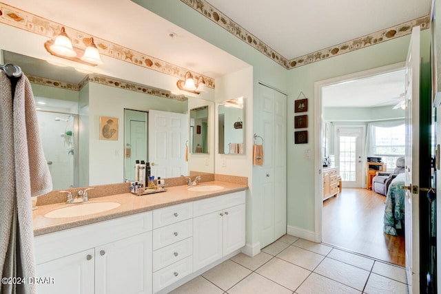 bathroom with an enclosed shower, vanity, hardwood / wood-style floors, and ceiling fan