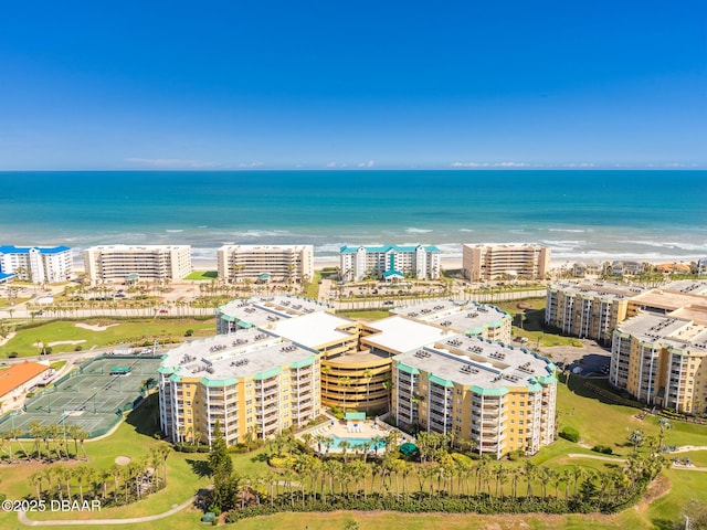 birds eye view of property featuring a view of city, a beach view, and a water view