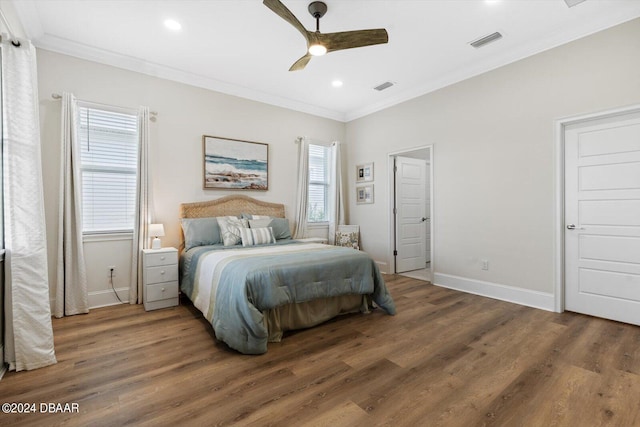 bedroom with ceiling fan, multiple windows, and dark hardwood / wood-style flooring