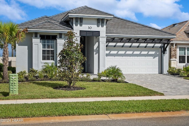 view of front facade with a garage and a front yard