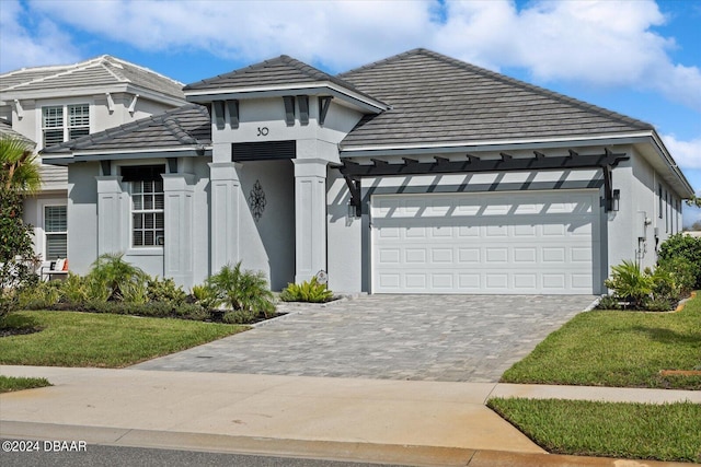 view of front of house featuring a front lawn and a garage