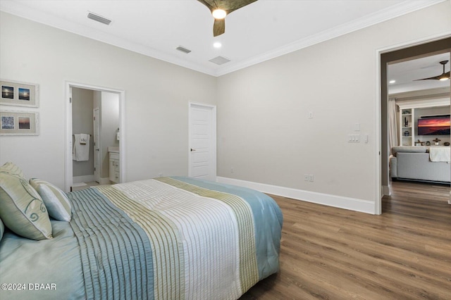 bedroom featuring dark wood-type flooring, ornamental molding, ceiling fan, and ensuite bathroom