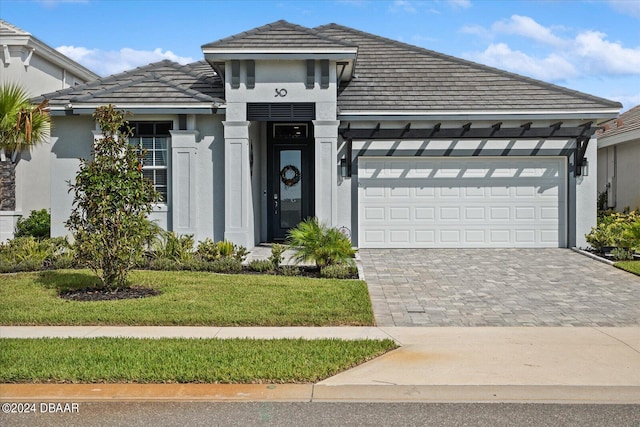 view of front of home with a front lawn and a garage