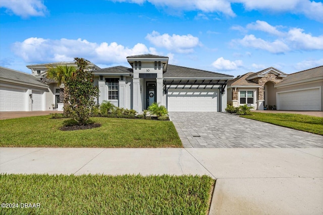 view of front facade with a garage and a front yard