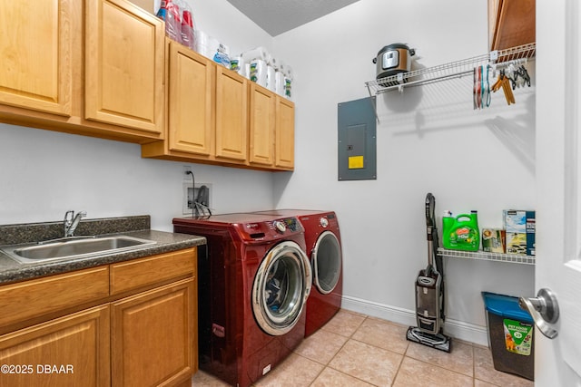 laundry room featuring a sink, electric panel, washer and dryer, cabinet space, and light tile patterned flooring