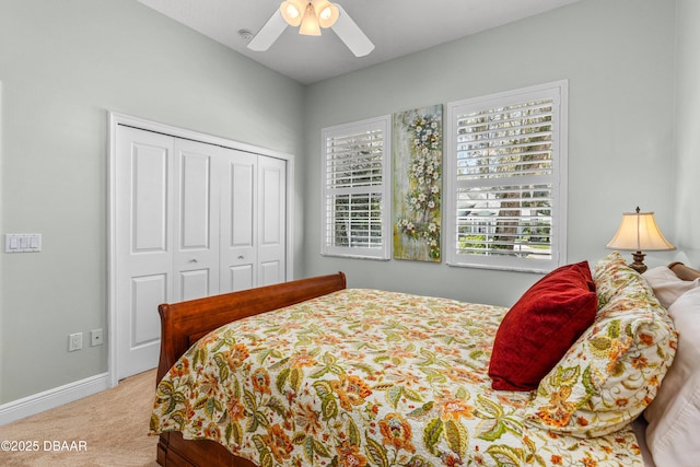 carpeted bedroom with a ceiling fan, baseboards, and a closet