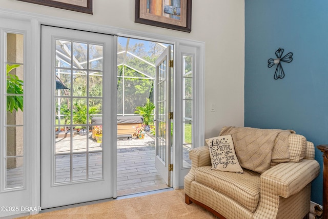 entryway featuring a wealth of natural light, carpet, and a sunroom