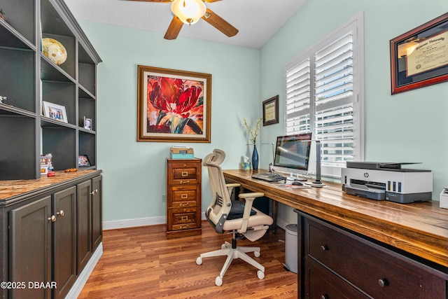 office with baseboards, light wood-type flooring, and a ceiling fan