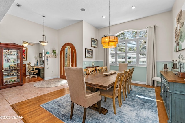 dining area with light tile patterned floors, baseboards, visible vents, and a chandelier