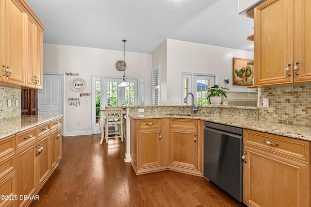 kitchen with light stone countertops, a peninsula, a sink, dark wood-type flooring, and dishwasher