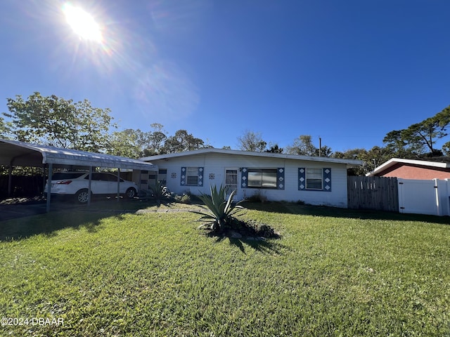 single story home featuring a front yard and a carport