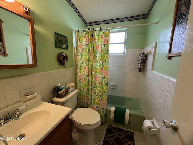 full bathroom featuring tile patterned flooring, tile walls, shower / tub combo with curtain, and a textured ceiling