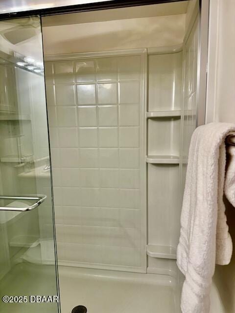 bathroom with a shower with door