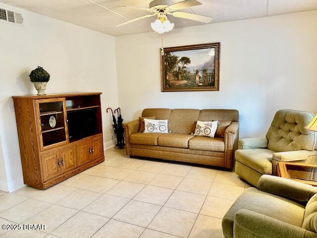 living room featuring light tile patterned flooring and ceiling fan