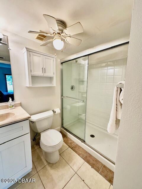 bathroom with vanity, tile patterned flooring, ceiling fan, and walk in shower