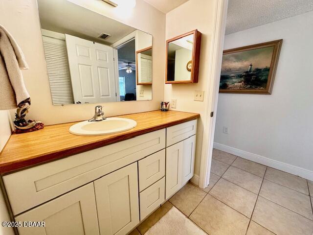 bathroom with vanity, tile patterned floors, and a textured ceiling