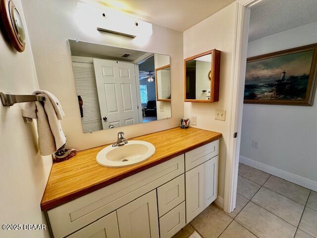 bathroom featuring vanity, tile patterned floors, and ceiling fan