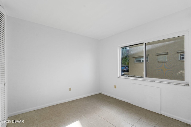 spare room featuring baseboards