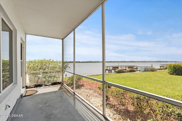 unfurnished sunroom with a water view