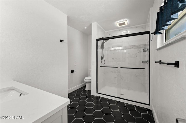 bathroom with visible vents, toilet, a stall shower, baseboards, and vanity