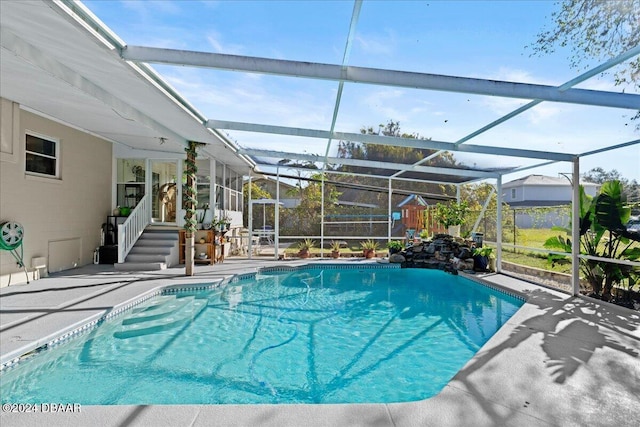 outdoor pool with a patio and a lanai