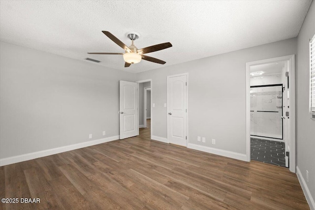 unfurnished bedroom with wood finished floors, visible vents, and a textured ceiling