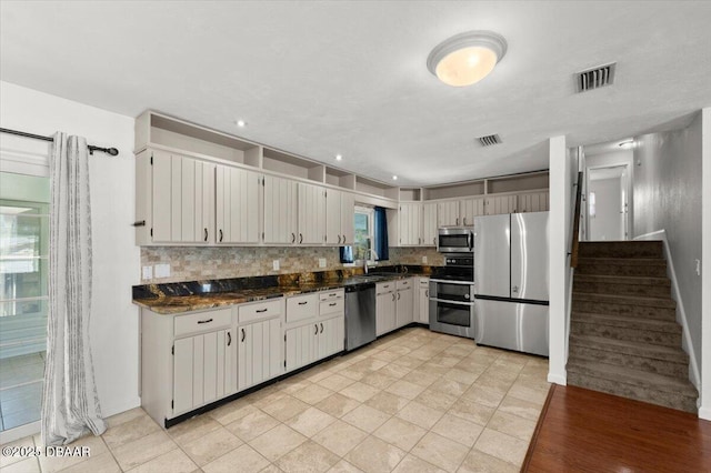 kitchen with tasteful backsplash, visible vents, and appliances with stainless steel finishes